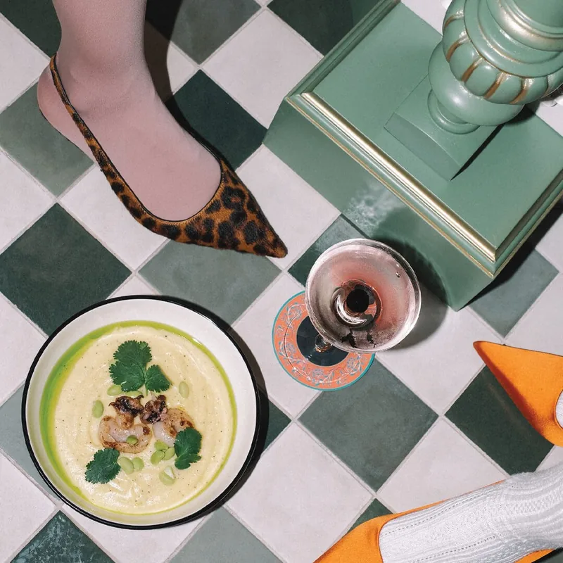 A light plate and a glass on a green checkerboard table