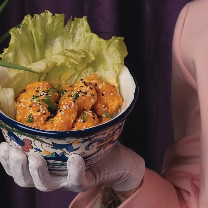 Finger food in a painted bowl with lettuce